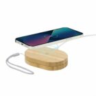 Smartphone charging wirelessly on a wooden charging pad with a cable attached.