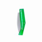 Green climbing hold attached to a white wall.