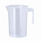 Transparent measuring jug with a handle and spout, marked with measurements.