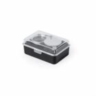 Clear-lidded black food container with a matching black utensil inside.