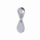 Silver folding 30x magnifying loupe on a white background.