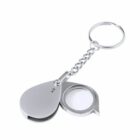 Silver magnifying glass keychain with a folding design.