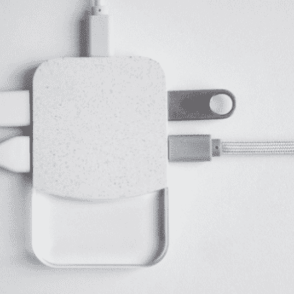 Charging hub with various connected cables on white background.