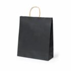 A plain black paper shopping bag with a sturdy gold twisted handle, standing upright against a white background.