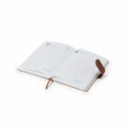 Open planner with visible calendar dates on pages, including 17 and 18. It features a brown leather cover and bookmark. The planner is placed on a white background.