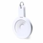 White plastic set of circular measuring spoons stacked on a metal ring, isolated on white.