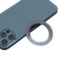 Smartphone camera lens protector ring next to a phone with three rear cameras.