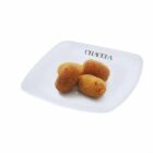 Four golden croquettes on a white plate with CHAGELA written on it.