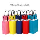 Colorful gift bags with black handles, tagline reads PMS matching is available.