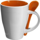 White mug with orange interior and an orange spoon resting in the handle.
