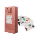 A pink gift bag with assorted decorative stickers nearby.
