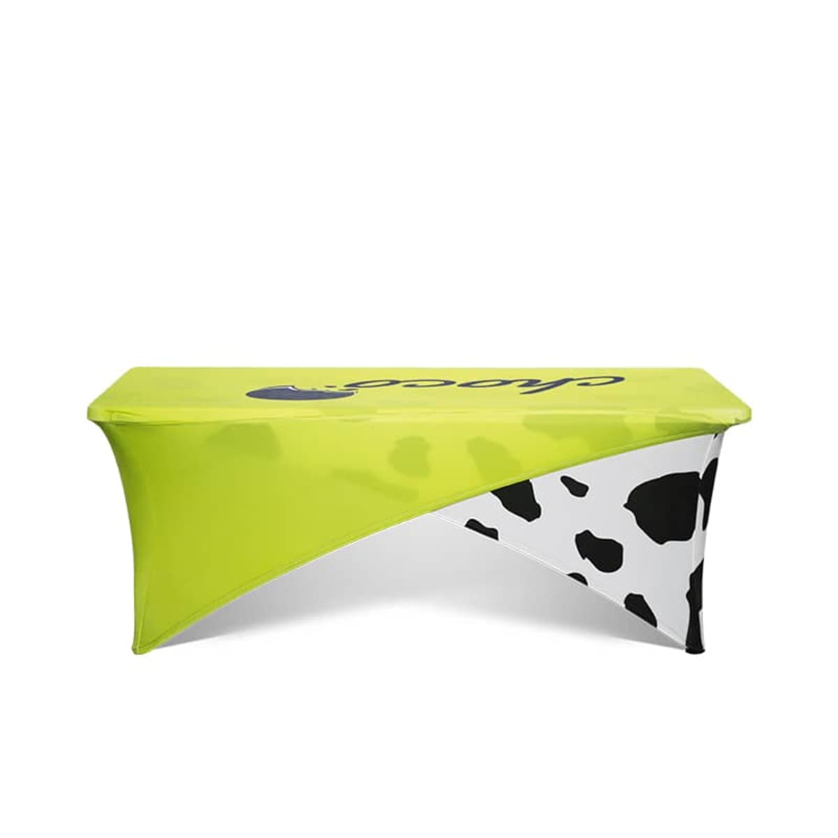 Lime green table cover with black and white cow print accents.