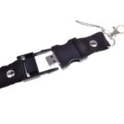 A black lanyard with a built-in USB flash drive, partially detached to reveal the USB connector. The lanyard is secured with a metal clasp and features a small circular metal attachment for keys or cards.