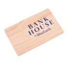 Wooden card with BANK HOUSE By BlueEarth printed in black and blue text.