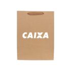 Brown paper bag with CAIXA printed in white and a handle at the top.