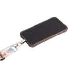 Smartphone with a transparent case attached to a colorful lanyard featuring cartoon designs. The phone is lying face up on a plain white surface, showcasing its screen and lanyard attachment.