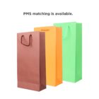 Three paper bags in brown, orange, and green with handles, under text about PMS matching.