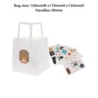 White paper bag with a bear print and scattered colorful sticker sheets nearby.