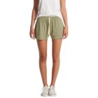 Person in a white shirt and green shorts, wearing white sneakers.