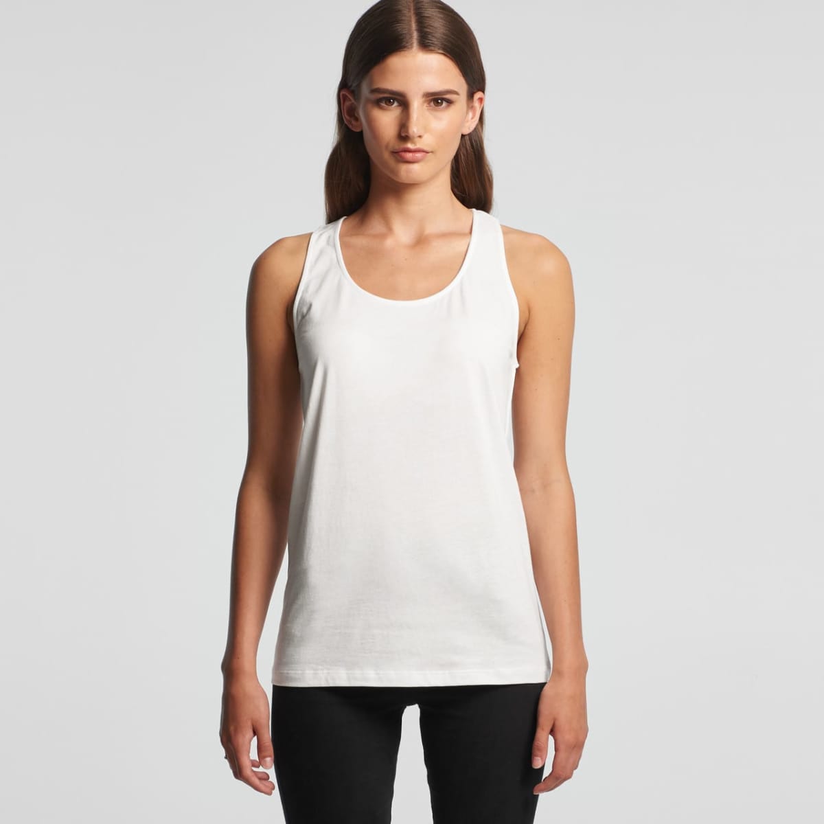 Person in a white tank top and black pants against a plain background.