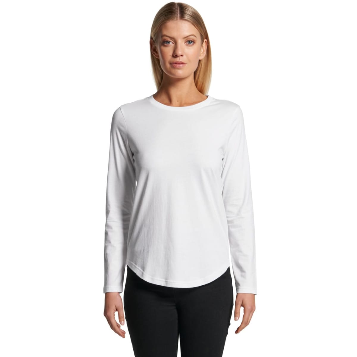 Woman in a white long-sleeve shirt and black pants, standing against a white background.
