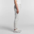 Person in light gray sweatpants, white T-shirt, and white sneakers standing sideways.