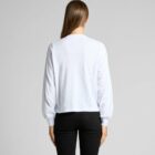 Person wearing white long-sleeve shirt and black pants, facing away.