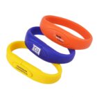 Three colorful silicone wristbands with various logos: orange, blue, and yellow.