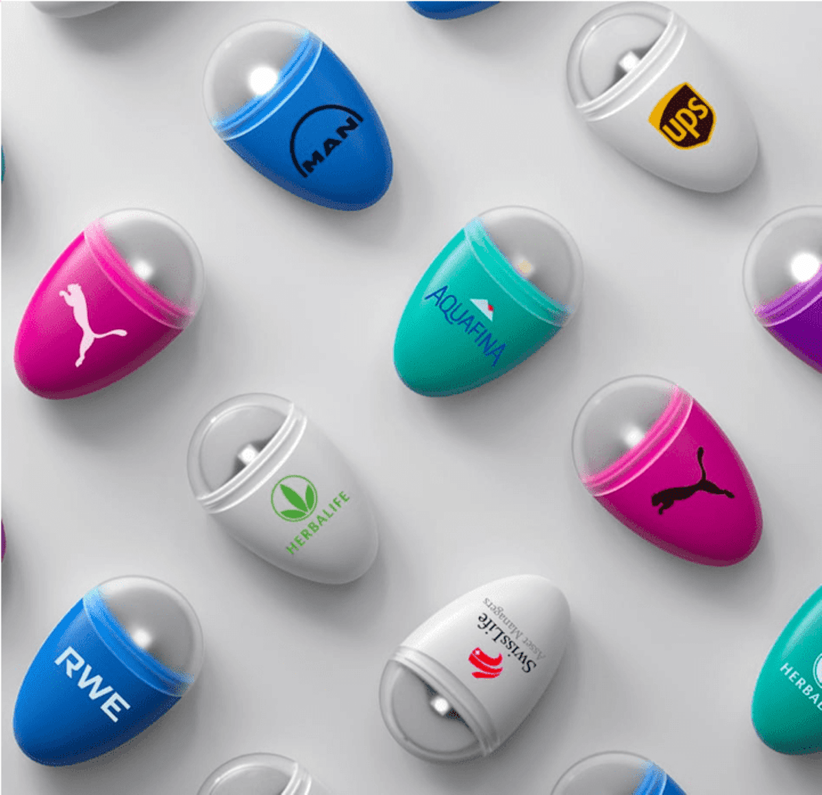Capsules with popular brand logos on a white background in a diagonal arrangement.