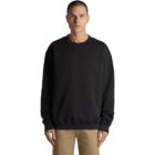 Person in a black sweatshirt and beige pants standing against a white background.