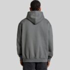 Person wearing a gray hoodie and black pants, seen from the back.
