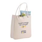 Canvas tote bag with a slogan, holding a pack of chips.