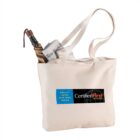Beige tote bag with logos, holding a newspaper and a closed umbrella.