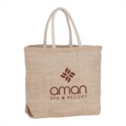 Beige tote bag with aman Spa & Resort logo and floral design.