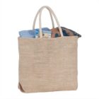 Beige tote bag with clothes and a magazine inside.