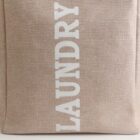 Beige fabric bag with LAUNDRY written in white text.