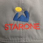 Gray fabric with embroidered blue icon, yellow circle, and red text STARONE.