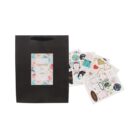 Black gift bag with floral card, surrounded by various colorful sticker sheets.