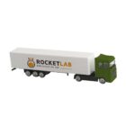 Toy truck with Rocket Lab logo on its white trailer and a green cab.