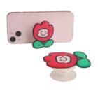 Phone with a flower-shaped pop grip and a similar grip displayed separately.