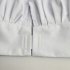 Close-up of white fabric with pleats and a velcro fastening.