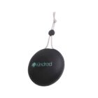 Round black portable speaker with Kindred logo, hanging by a cord.