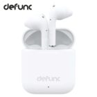 White Defunc wireless earbuds in an open charging case, with Defunc logo visible.
