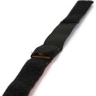 A black Velcro cable tie on a white background, partially wrapped around itself. The tie appears to be made of a soft, flexible material designed for securing and organizing cables.