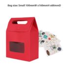 Red gift bag with a clear window, next to various sheets of colorful stickers.