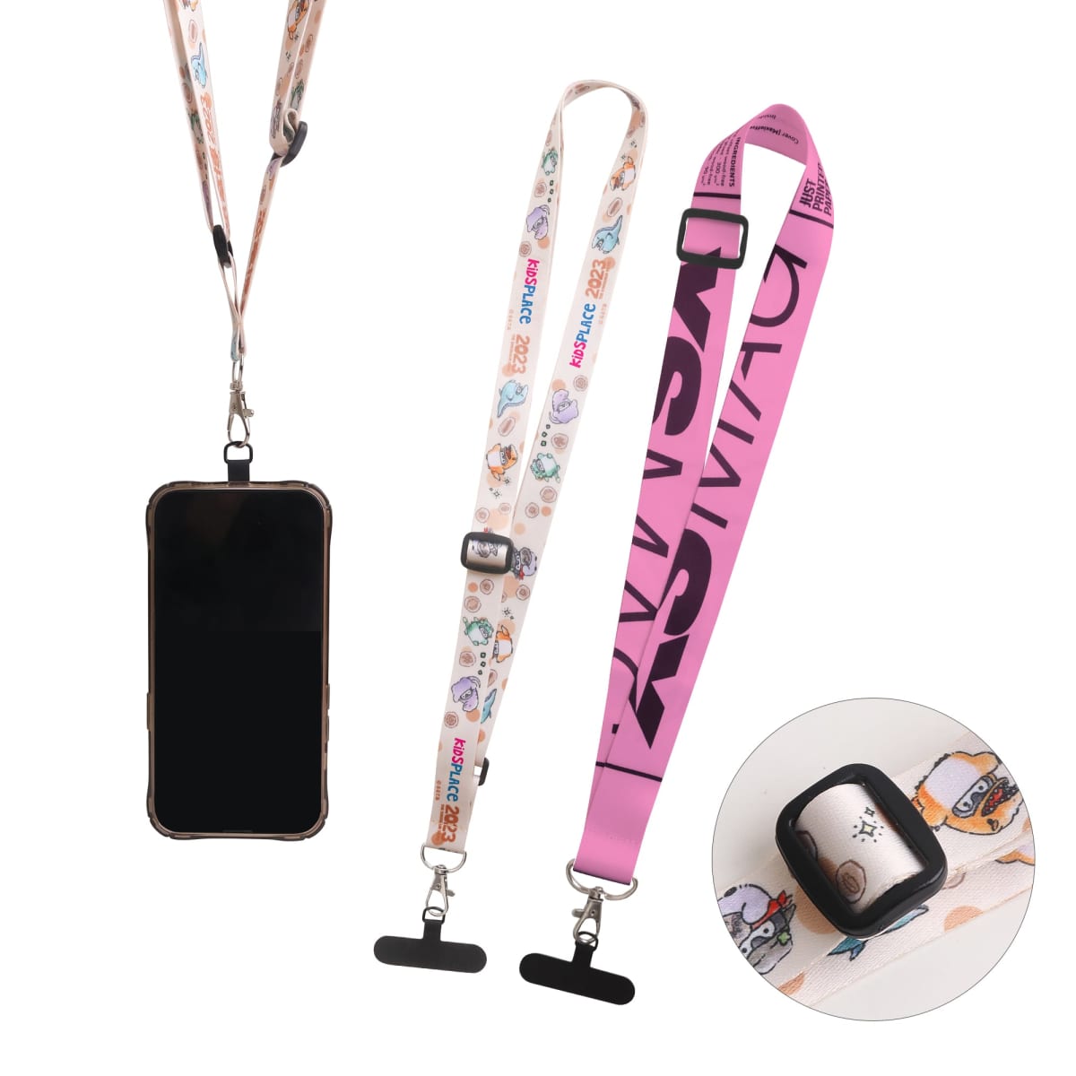 Three smartphone lanyards are shown: one is black attached to a phone, another is white with cartoon designs, and the third is pink with bold text. An inset shows a close-up of a black plastic connector attached to a fabric lanyard.
