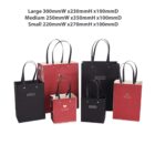 Black and red gift bags with heart details, in three different sizes.