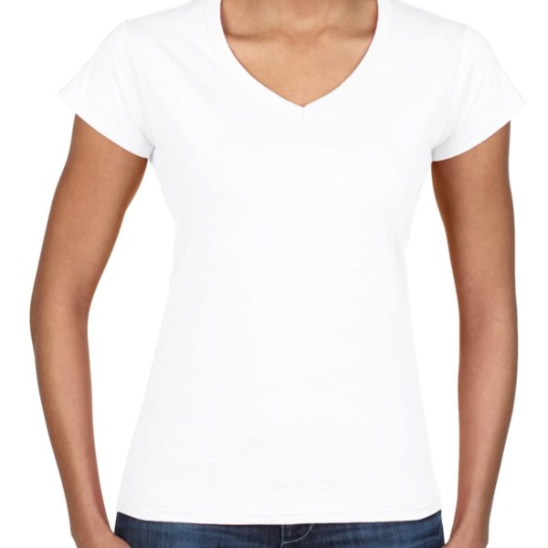 Smiling woman wearing a plain white V-neck T-shirt and blue jeans, standing upright.