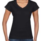 Woman wearing a plain black V-neck T-shirt and blue jeans, smiling.