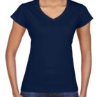 Woman wearing a plain navy blue V-neck T-shirt and blue jeans, smiling.